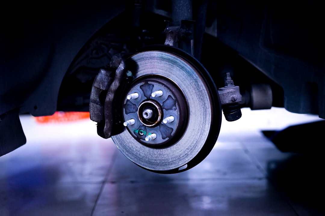 Close-up view of car brake disc and suspension system showing brake components
