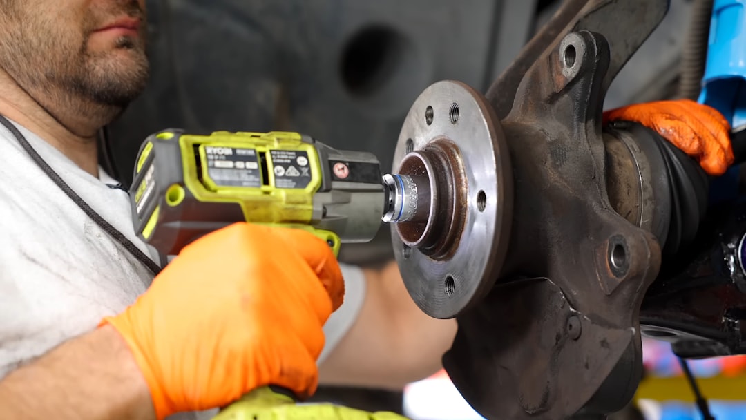 Professional brake service mechanic working on vehicle brake system repair