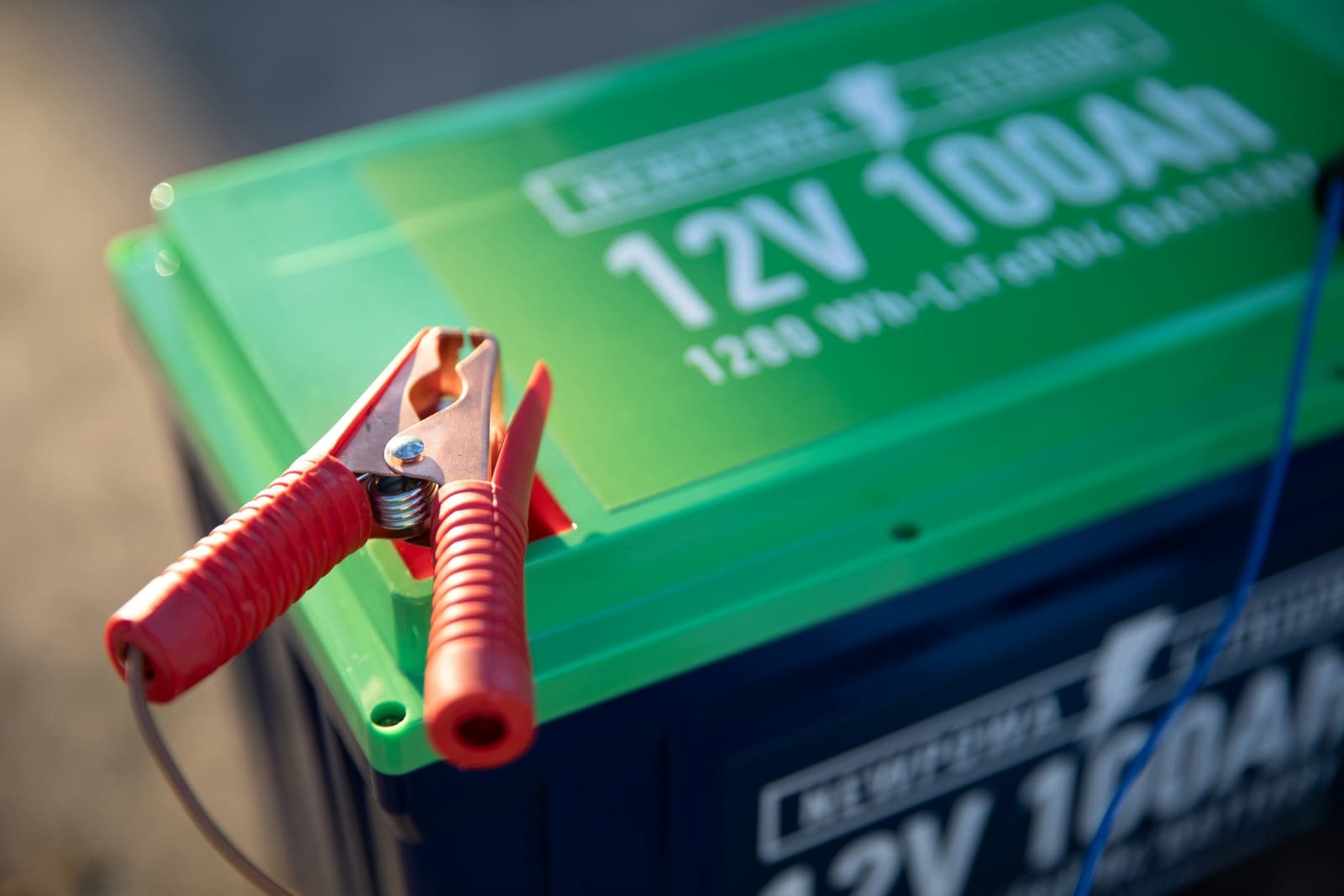 12-volt car battery with service clamps ready for winter testing