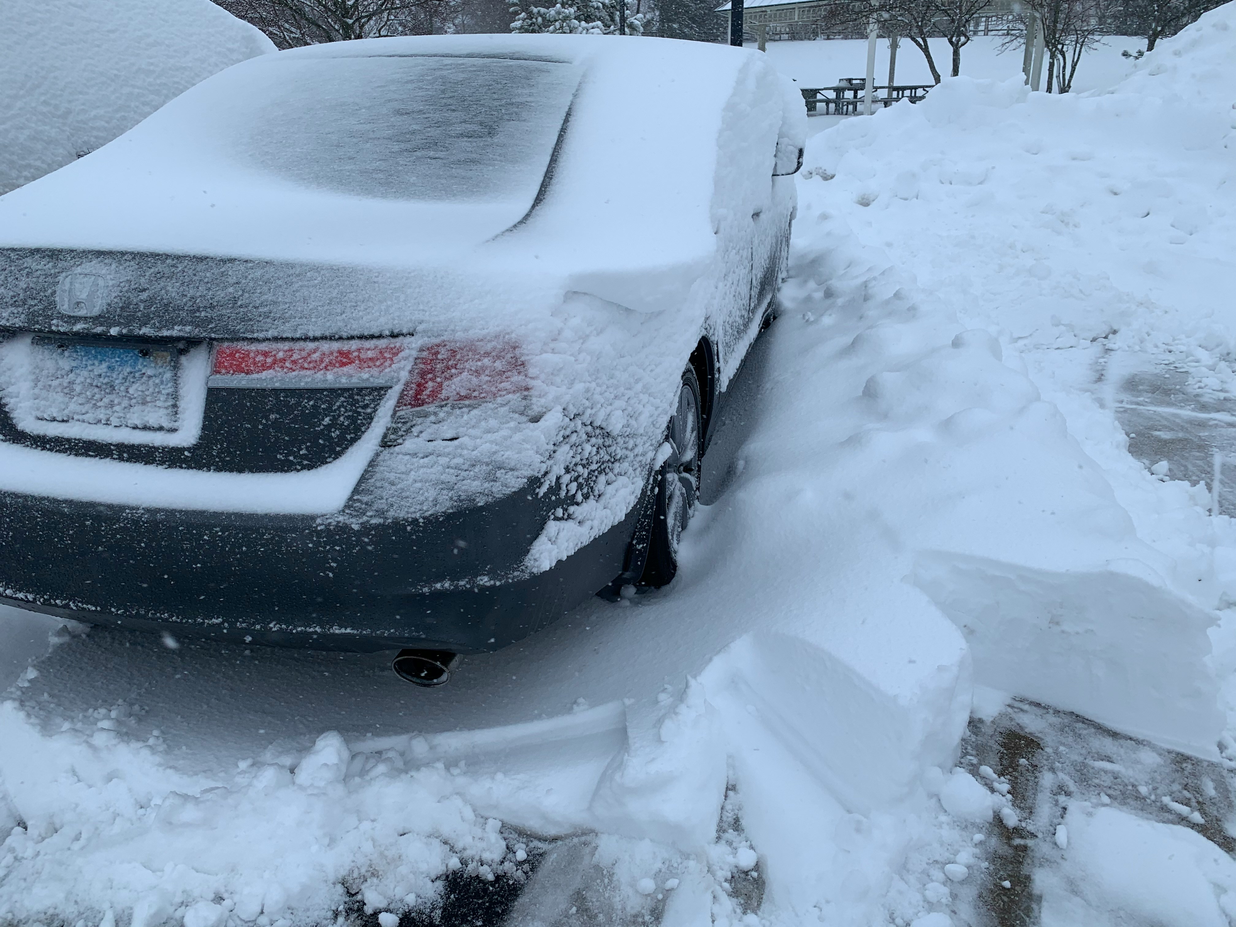 Car completely covered in deep snow after Chicago winter blizzard - emergency kit importance