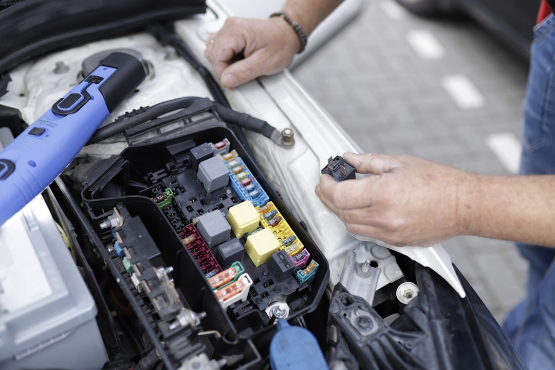 Car mechanic working on automotive electronics